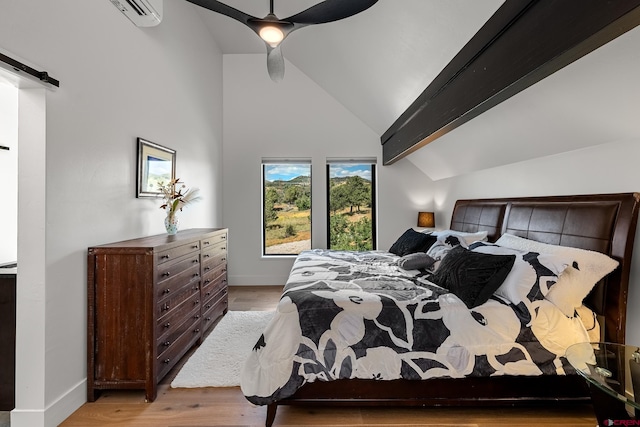 bedroom with ceiling fan, vaulted ceiling with beams, light hardwood / wood-style floors, and an AC wall unit