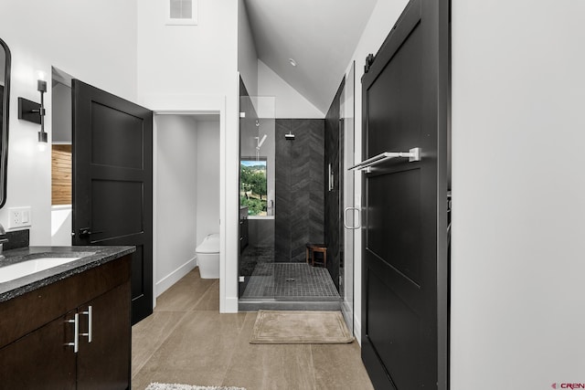 bathroom featuring vaulted ceiling, walk in shower, tile patterned floors, vanity, and toilet