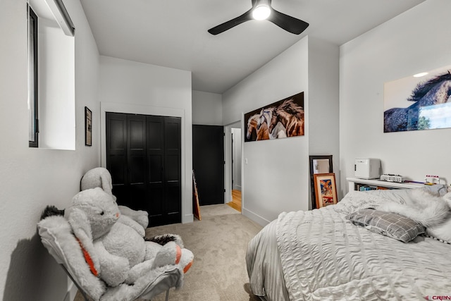 carpeted bedroom with ceiling fan and a closet