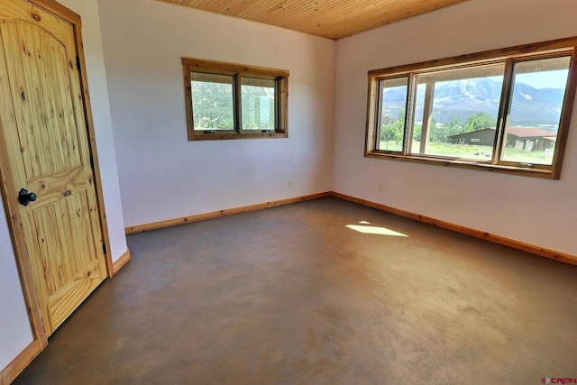 unfurnished bedroom featuring multiple windows and wood ceiling