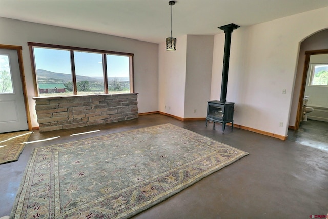 unfurnished living room with a wood stove