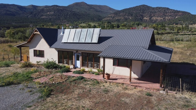 modern inspired farmhouse with a mountain view and a patio area