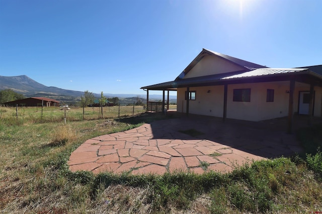 view of yard with a mountain view, a rural view, and a patio area