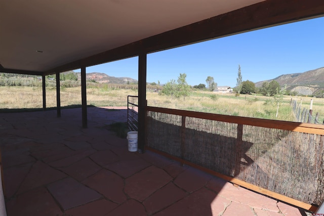 view of patio / terrace featuring a mountain view and a rural view