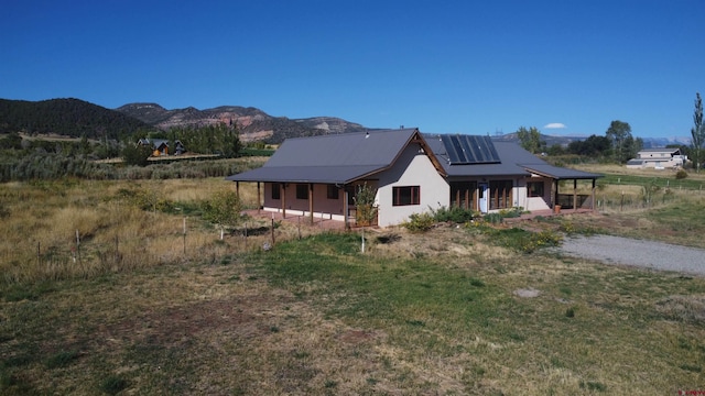 view of front of house featuring a mountain view and covered porch