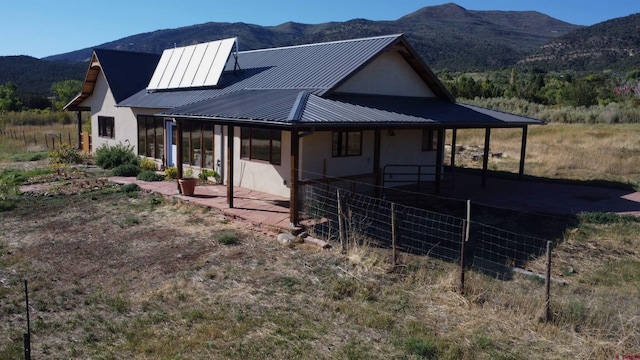 exterior space featuring a mountain view and a patio area