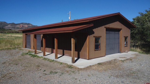 view of outbuilding with a mountain view and a garage