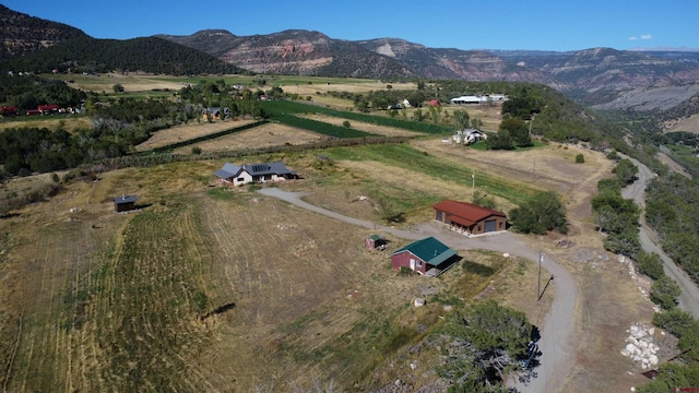 birds eye view of property with a mountain view and a rural view