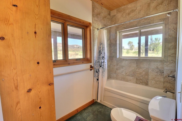 bathroom featuring shower / bath combo and toilet