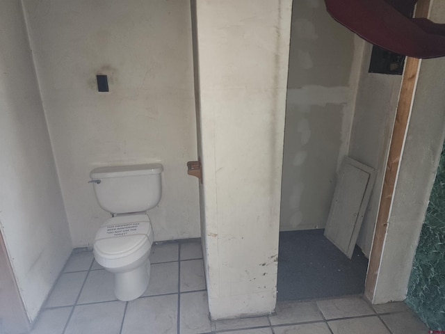 bathroom with tile patterned flooring and toilet