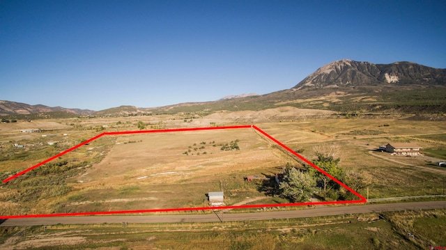 birds eye view of property with a mountain view and a rural view