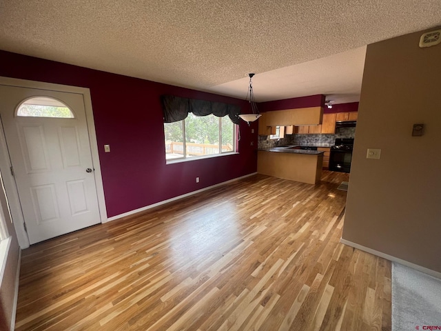 unfurnished living room featuring a textured ceiling and wood-type flooring