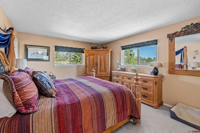 bedroom with light carpet and a textured ceiling