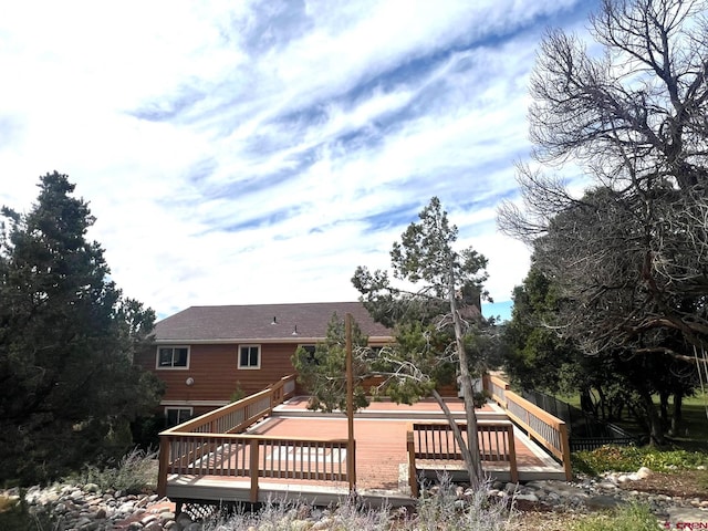 rear view of property featuring a deck