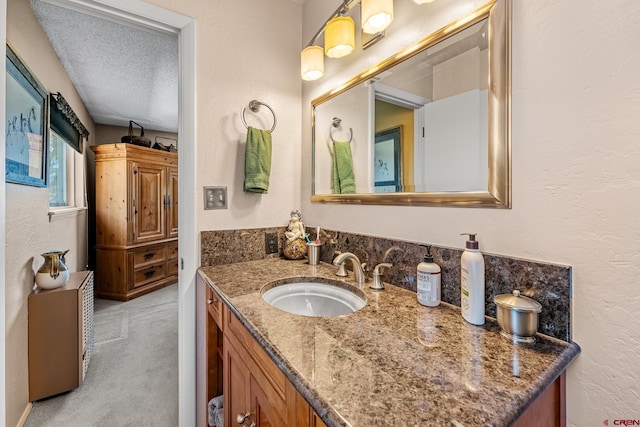 bathroom with a textured ceiling and vanity