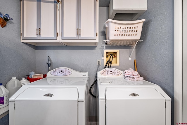 washroom with separate washer and dryer and cabinets