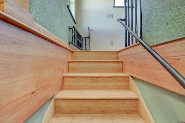 staircase with wood walls