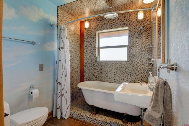 bathroom featuring shower with separate bathtub, tile patterned flooring, and toilet