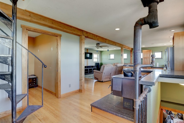 kitchen with ceiling fan and light hardwood / wood-style flooring