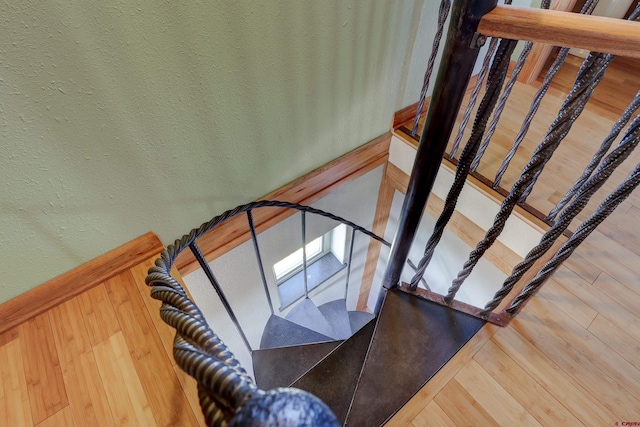 stairs with wood-type flooring