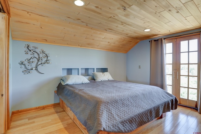 bedroom featuring wood ceiling, light hardwood / wood-style floors, and lofted ceiling