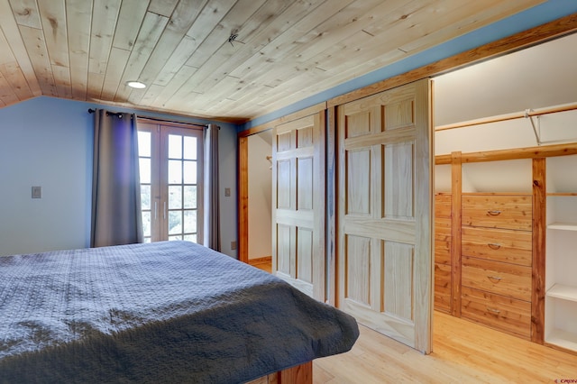 bedroom featuring light wood-type flooring, lofted ceiling, and wooden ceiling