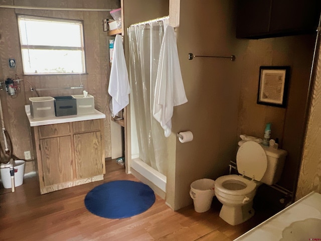 bathroom featuring curtained shower, hardwood / wood-style floors, vanity, and toilet