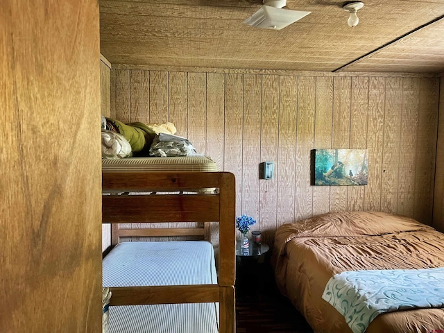 bedroom with wooden walls and wooden ceiling