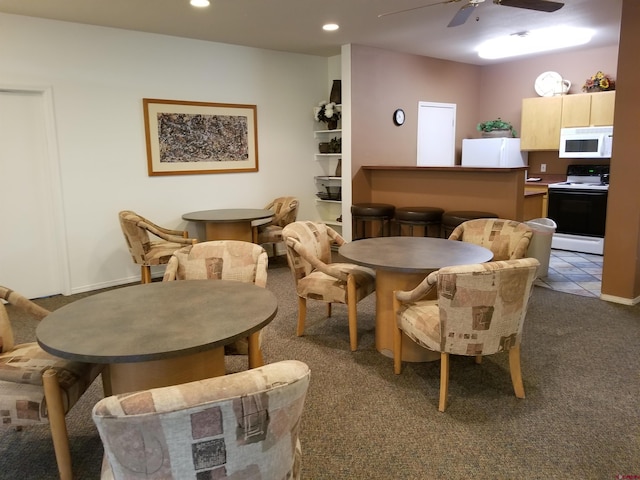 dining space featuring carpet floors, a ceiling fan, and recessed lighting