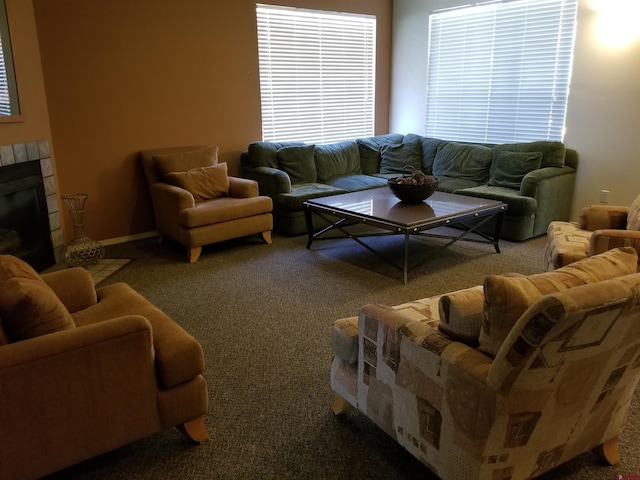 carpeted living room featuring a tile fireplace