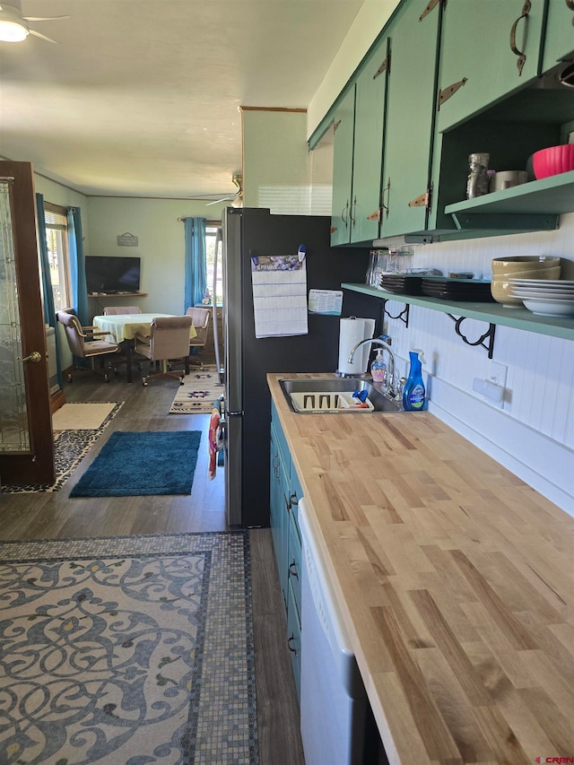 kitchen with dark hardwood / wood-style floors, ceiling fan, sink, and white dishwasher