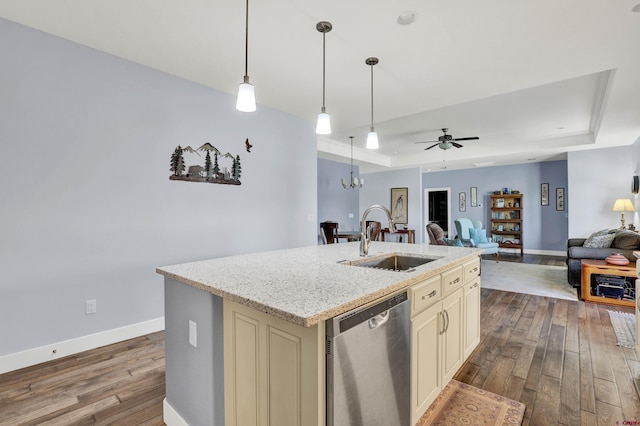 kitchen featuring sink, cream cabinets, a center island with sink, dishwasher, and ceiling fan with notable chandelier