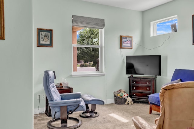 sitting room featuring light colored carpet and a wealth of natural light