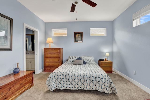 carpeted bedroom with ceiling fan and connected bathroom