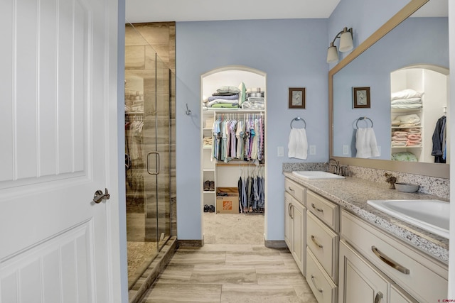 bathroom featuring vanity and an enclosed shower