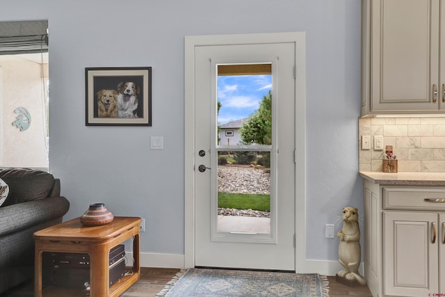 doorway with dark wood-type flooring