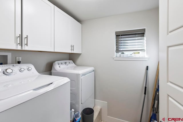 washroom with washer and clothes dryer and cabinets