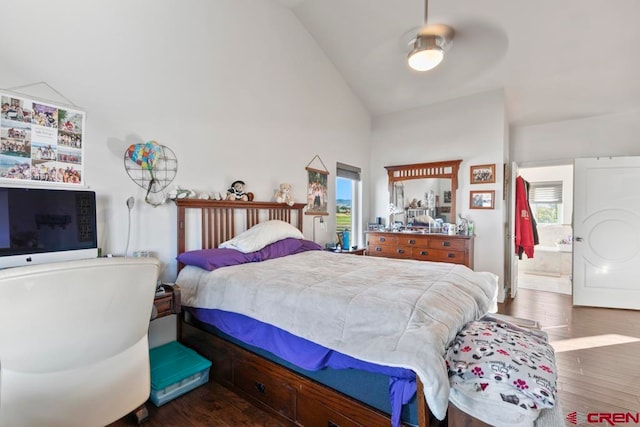 bedroom featuring multiple windows, connected bathroom, ceiling fan, and dark wood-type flooring