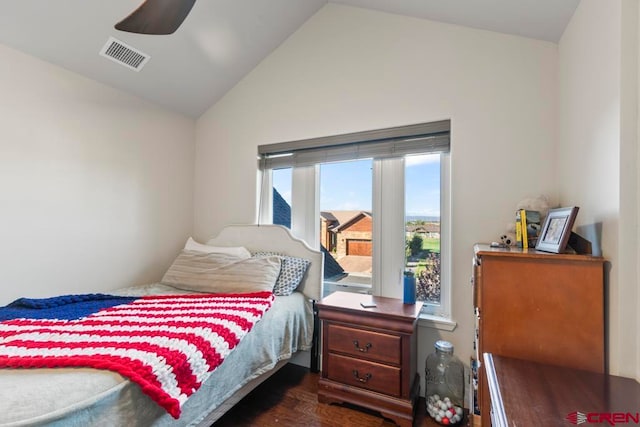 bedroom with vaulted ceiling, ceiling fan, and dark hardwood / wood-style floors