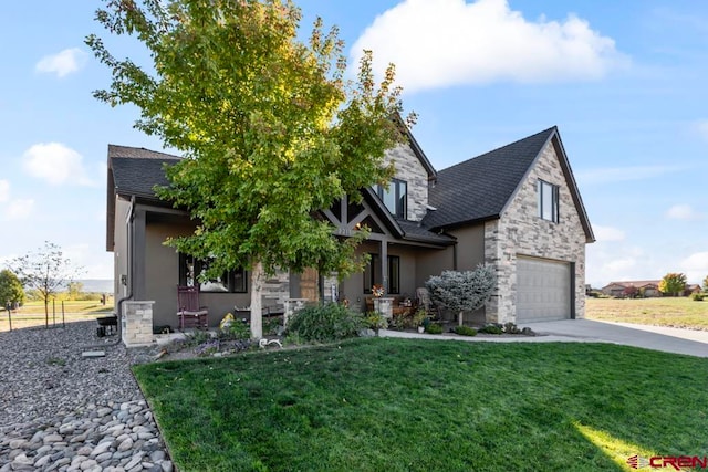 view of front of house featuring a porch, a garage, and a front yard