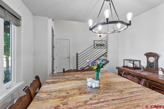 dining area with a healthy amount of sunlight and a chandelier