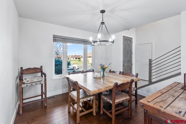 dining space with a chandelier and dark wood-type flooring