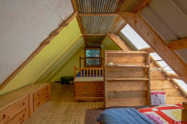 bedroom with light hardwood / wood-style floors and vaulted ceiling