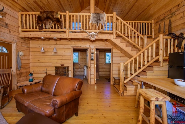 living room featuring vaulted ceiling, wood ceiling, and hardwood / wood-style floors