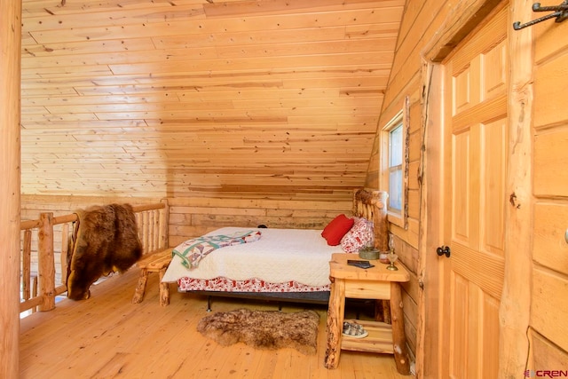 bedroom with hardwood / wood-style flooring, wooden walls, vaulted ceiling, and wooden ceiling