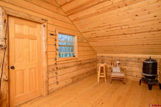 bonus room featuring light wood-type flooring, wood walls, wood ceiling, and vaulted ceiling