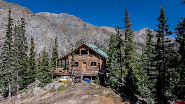 view of front of house featuring a deck with mountain view