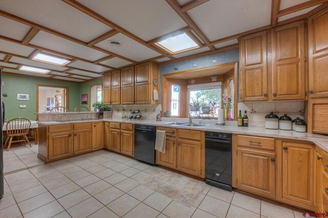 kitchen with dishwasher, sink, kitchen peninsula, backsplash, and light tile patterned floors