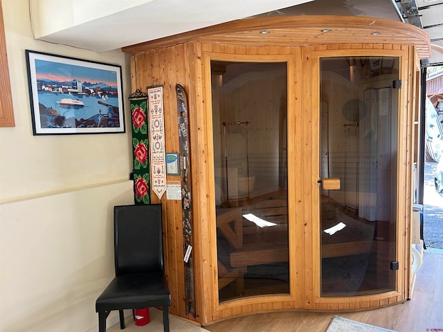 view of sauna with wood walls and hardwood / wood-style flooring