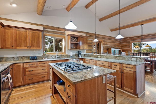 kitchen with pendant lighting, a kitchen breakfast bar, light wood-type flooring, and a center island